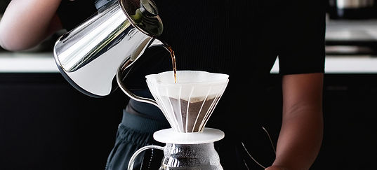 Firefly a young woman in her bright kitchen making ice coffee from a pour over 22549.jpg