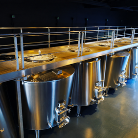Stainless steel fermentation tanks in a modern winery