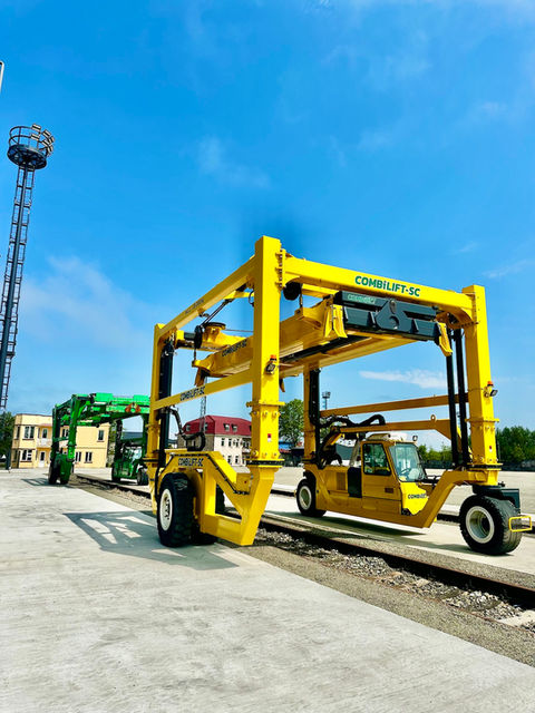 PLP Combilift two straddle carriers lined along the railway lines.