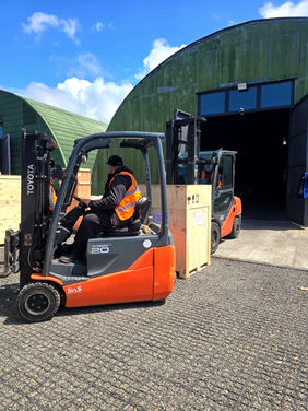 PLP forklifts carrying some cargo from the hangar warehouse