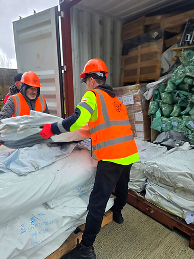 Two PLP workers unloading general cargo from the open container