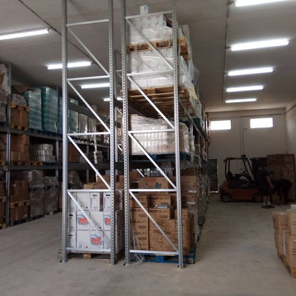 Expansive warehouse interior with multiple levels of industrial storage shelving used to house an extensive inventory of merchandise.
