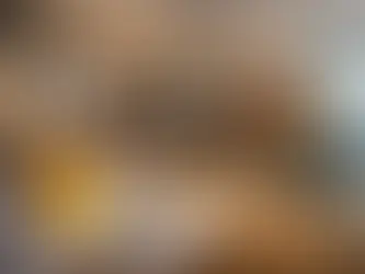 Office renovation in Singapore showing a worker installing ceiling services beside a modern glass-partitioned meeting room, representing smart office renovation cost planning.