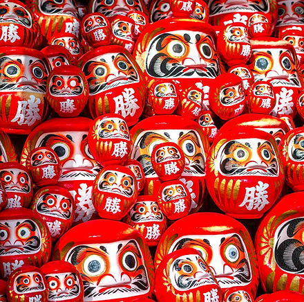 a pile of red and white painted skulls