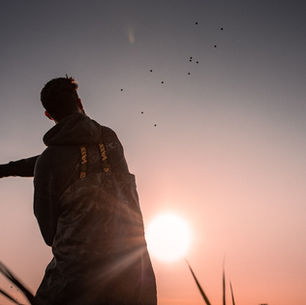 A man front og a gorgeous sunset.