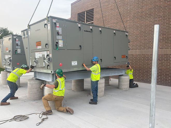 Commercial HVAC technicians installing rooftop equipment for a commercial building in the Twin Cities