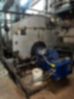 Commercial boiler system with blue burner assembly inside a mechanical room during an annual inspection and tune-up.