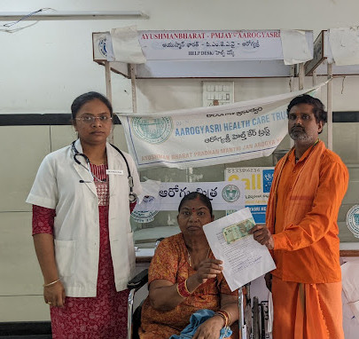 Doctor and man giving document to patient at Jagtial hospital