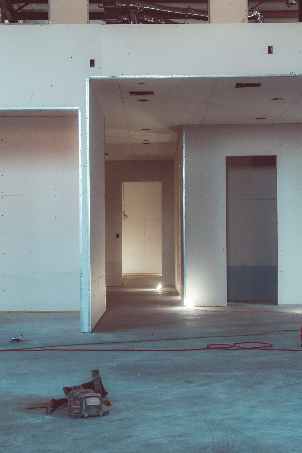 Drywall panels being installed in the new facility