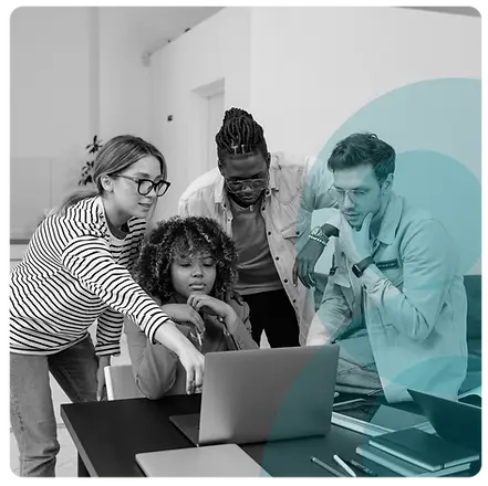 A group of people pointing at a laptop and discussing