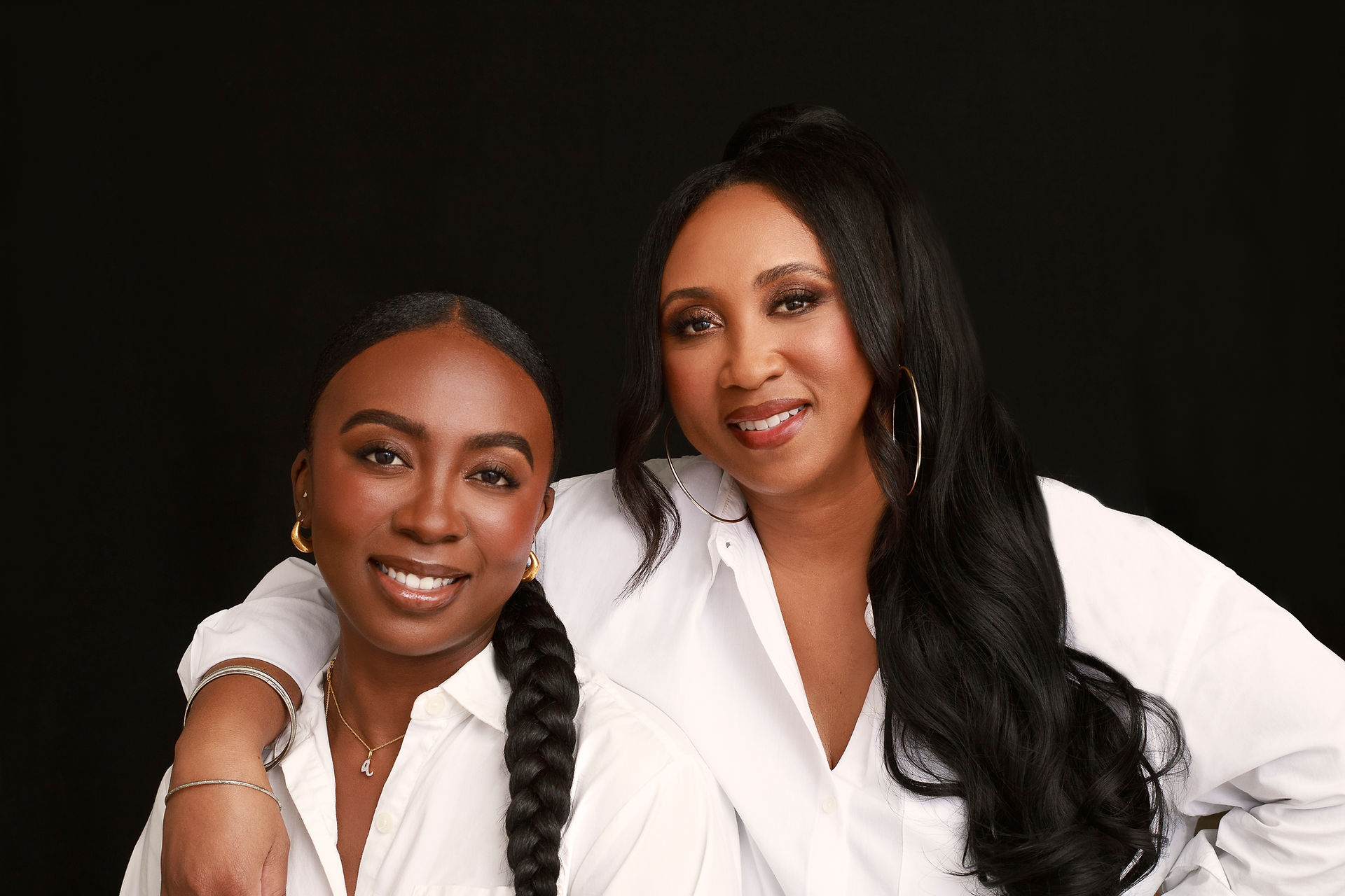 Portrait of mother and daughter in white shirts