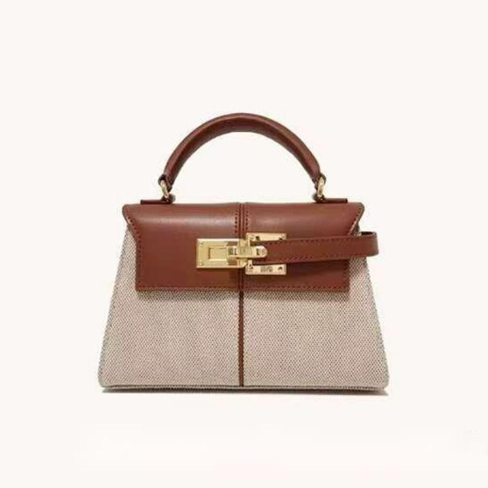 “Two-tone leather handbag in beige and brown with structured top handle and gold clasp closure, elegant sophisticated design