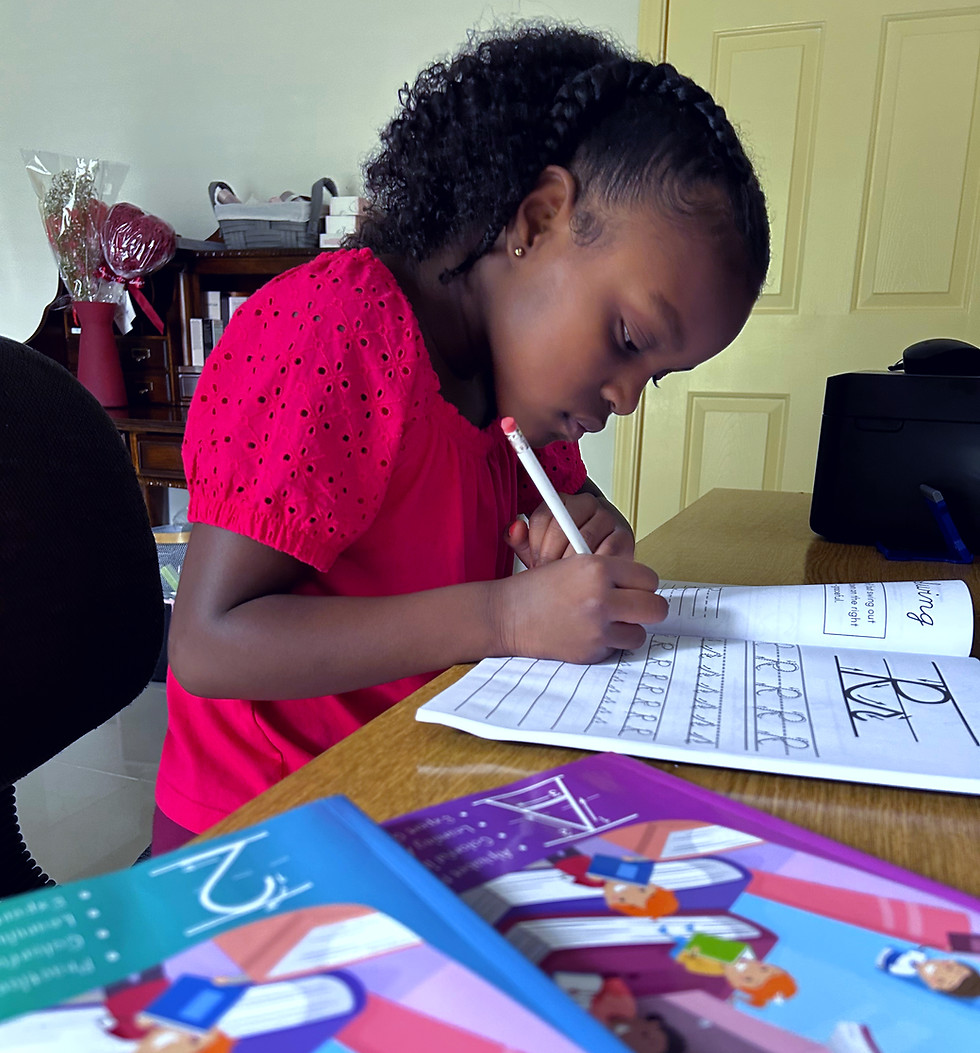 Little girl practicing writing the cursive letter R