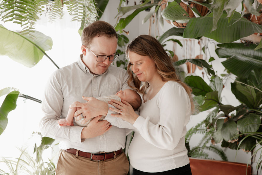 parents holding newborn baby in home studio Baltimore Maryland newborn photography