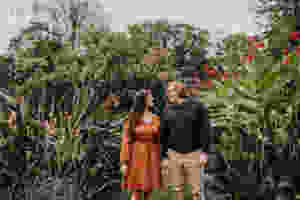 Flowers in background and woman and man holding hands in Baltimore Maryland