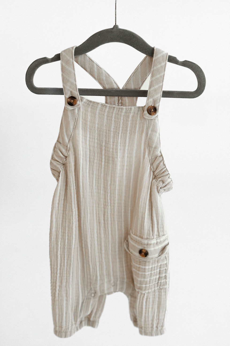 Striped overall outfits for Maryland milestone sessions. Soft neutrals and subtle patterns for a tim