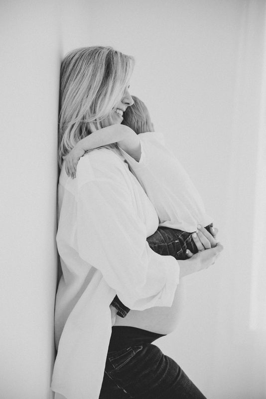 Mother holding newborn during lifestyle motherhood session | Baltimore newborn and maternity photographer