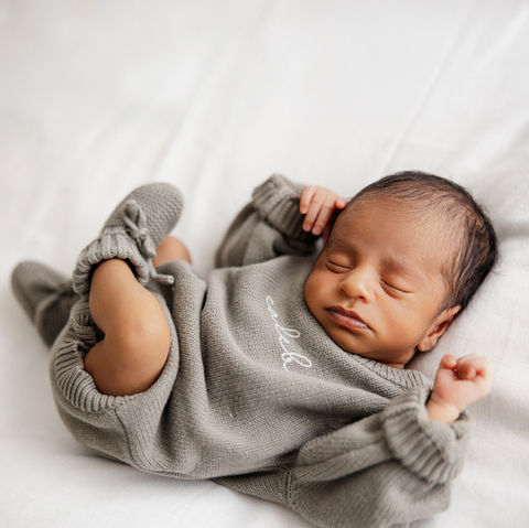 newborn baby boy in gray outfit sleeping Baltimore Maryland infant photography