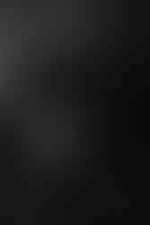 Baltimore boudoir photographer capturing confident pose on couch in studio