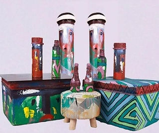 A set of colourful art pieces (boxes, stools, and more) made by upcycling trash by Aniefon Ben Edet