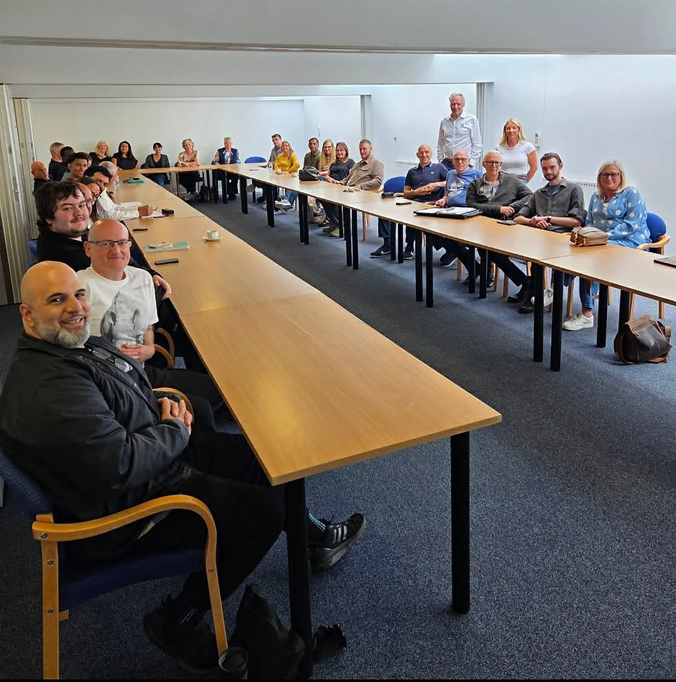 More than 30 PFE Medical colleagues seated in the conference room at the start of the company team day, ready for the annual review.