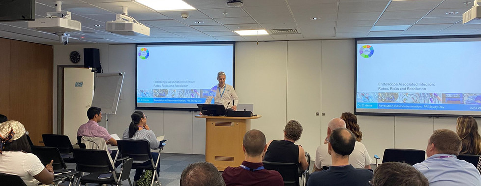 Malcolm presenting an analysis of recent hospital-acquired infection outbreaks linked to endoscope use. The discussion highlights probable causes of contamination and explains why manual cleaning of flexible endoscopes remains a critical vulnerability in infection control within healthcare facilities.