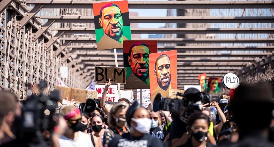 Thousands walk across the Brooklyn Bridge in New York on June 19, 2020, at a protest after the death of George Floyd. (Pew Research Center)