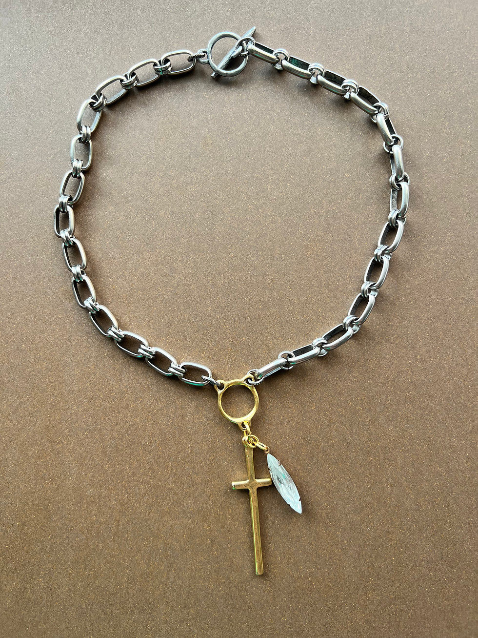 Thumbnail: dark silver toned chain with gold connector and long cross with rhinestone accent