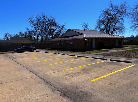 Apartment parking lot after being fixed and having lines painted.