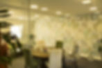 Meeting room chairs around table, map wallpaper