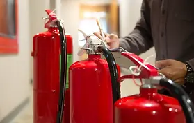 Hydrostatic testing of a fire extinguisher in a safety facility.