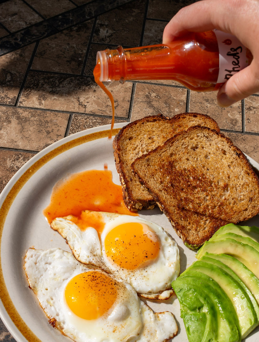 Rhed's - Original Hot Sauce with eggs, toast and avocado