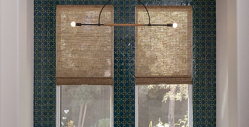 Elegant bathroom featuring a freestanding white bathtub placed against a dramatic dark teal accent wall with geometric tile