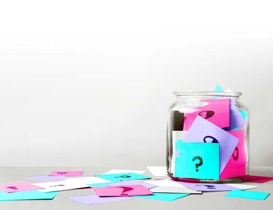 post-it notes with question marks on in a glass jar