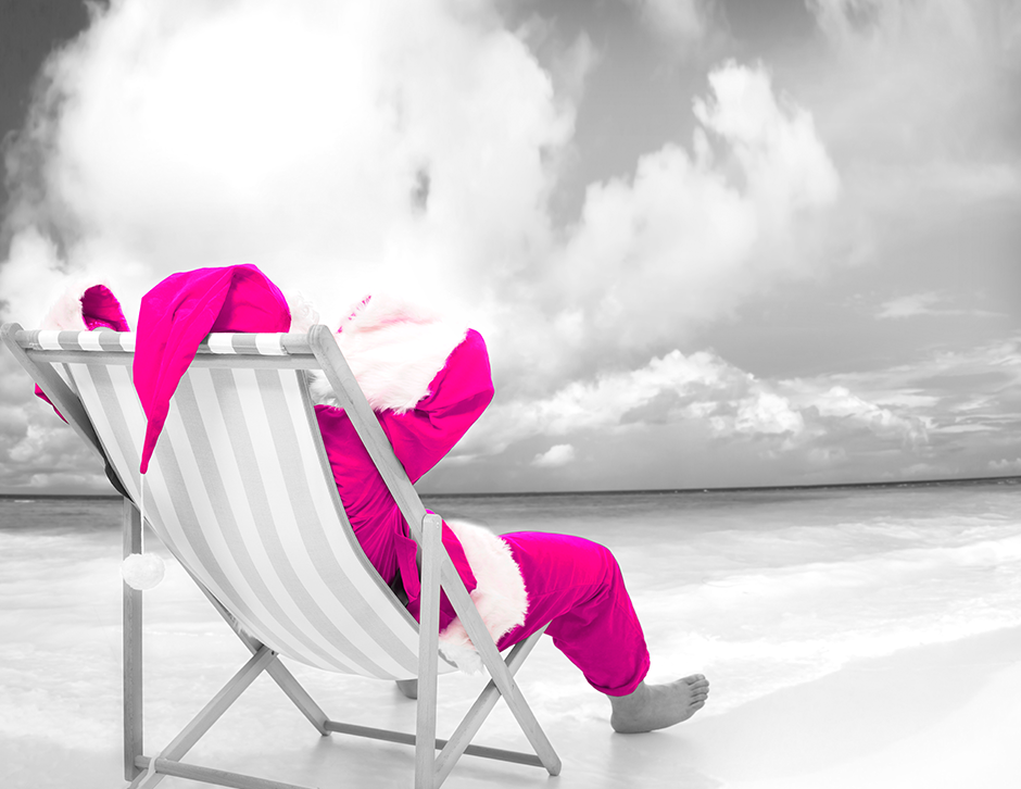 Santa Clause sitting on a deck chair with his feet on a sandy beach. Image for blog encouraging companies to plan your office christmas party early. 