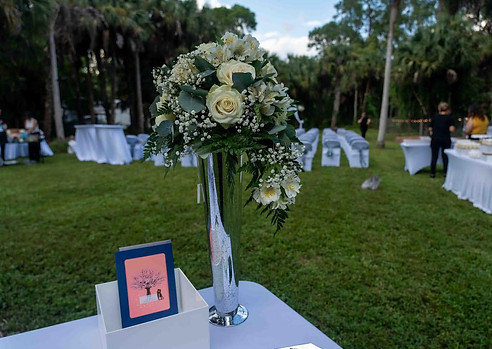 Elegant wedding ceremony setup with floral arrangement and seating for guests at an outdoor Southwest Florida wedding officiated by Dazzling Vows.