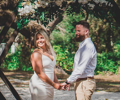 Outdoor elopement ceremony in Southwest Florida with wedding officiant and couple exchanging vows beneath historic oak tree