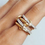 Thumbnail: Gold and silver pavé crystal link ring with layered interlocking design.