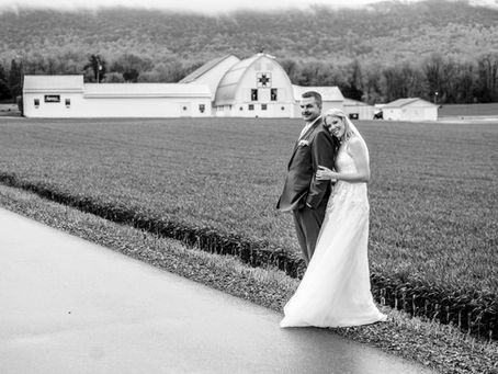 Rustic barn with a happy newlywed couple posed.
