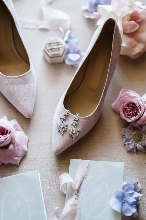 purple suede wedding shoes with earrings and vows booklets