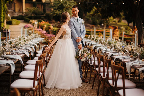 Bride and groom look at their wedding tables