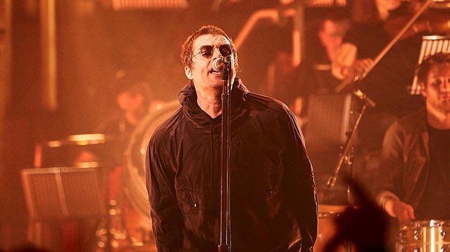 Liam gallagher performing live at Hull City Hall for MTV Unpluuged wearing a black pretty green white label jacket