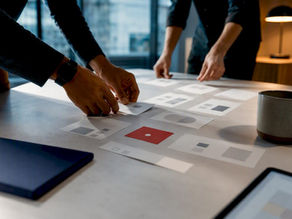 Hands arranging digital product roadmap cards