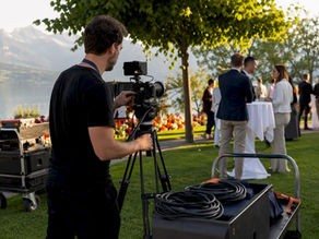 Video crew adjusting camera setup outdoors
