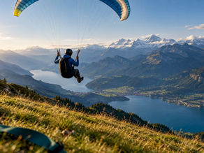 Paraglider above Interlaken lakes and Alps
