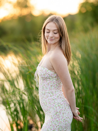 senior pictures by lake and tall grass