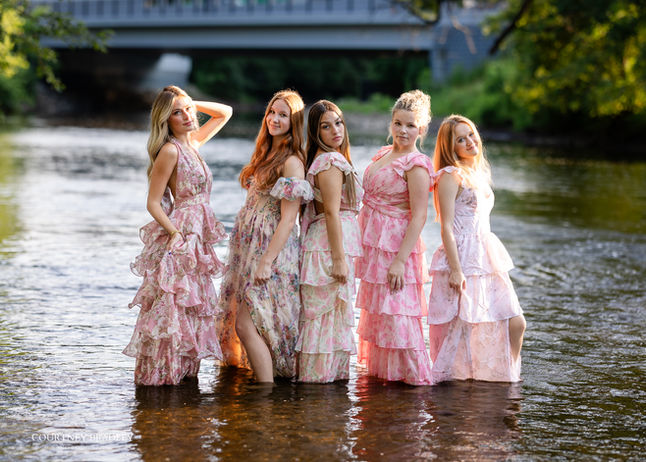 courtneys crew, hogh school senior rep team pictures in a river in lansing michigan wearing long flowy dresses