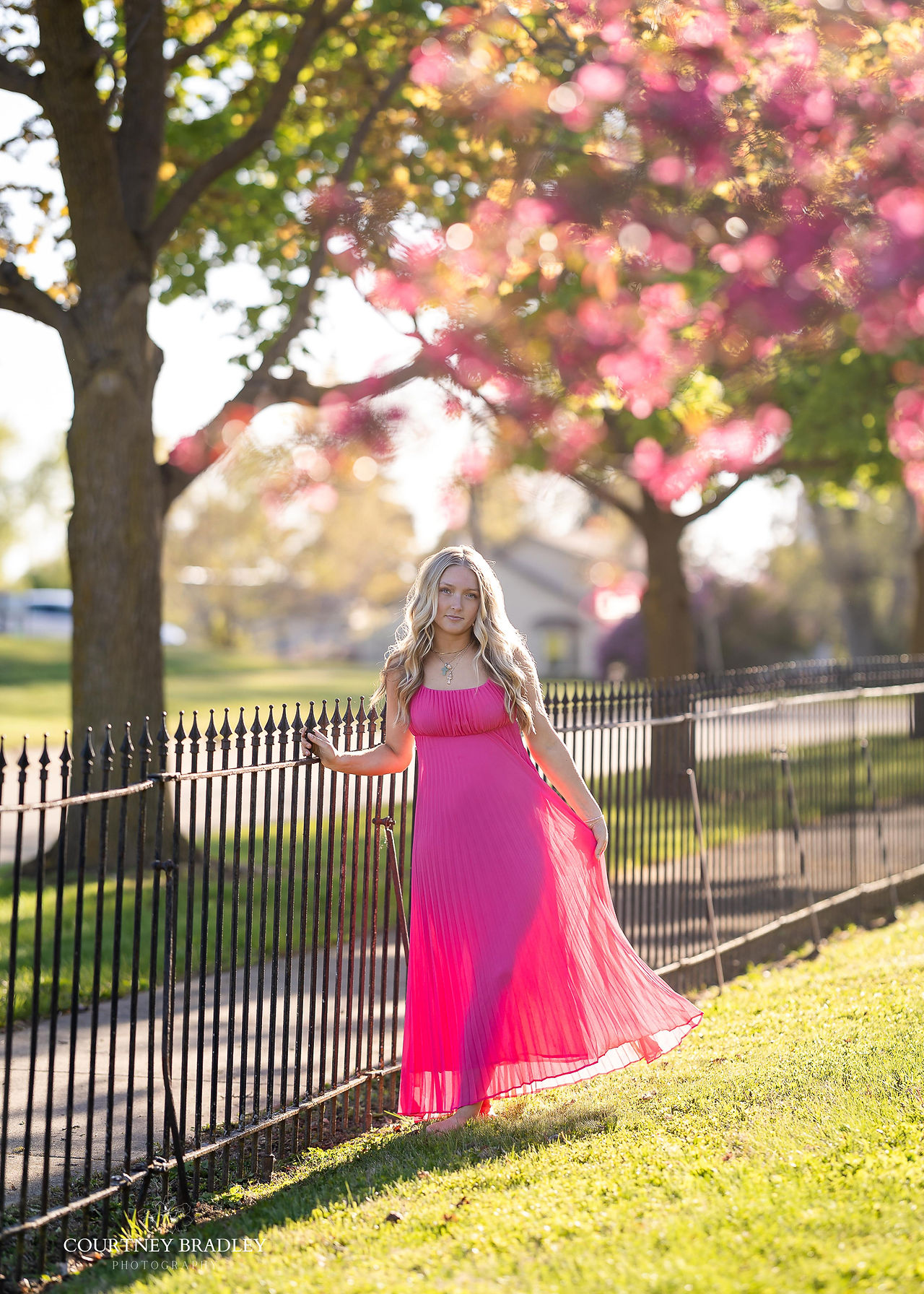 St. Johns Redwings senior girl photographed under blooming trees by Mid Michigan senior photographer