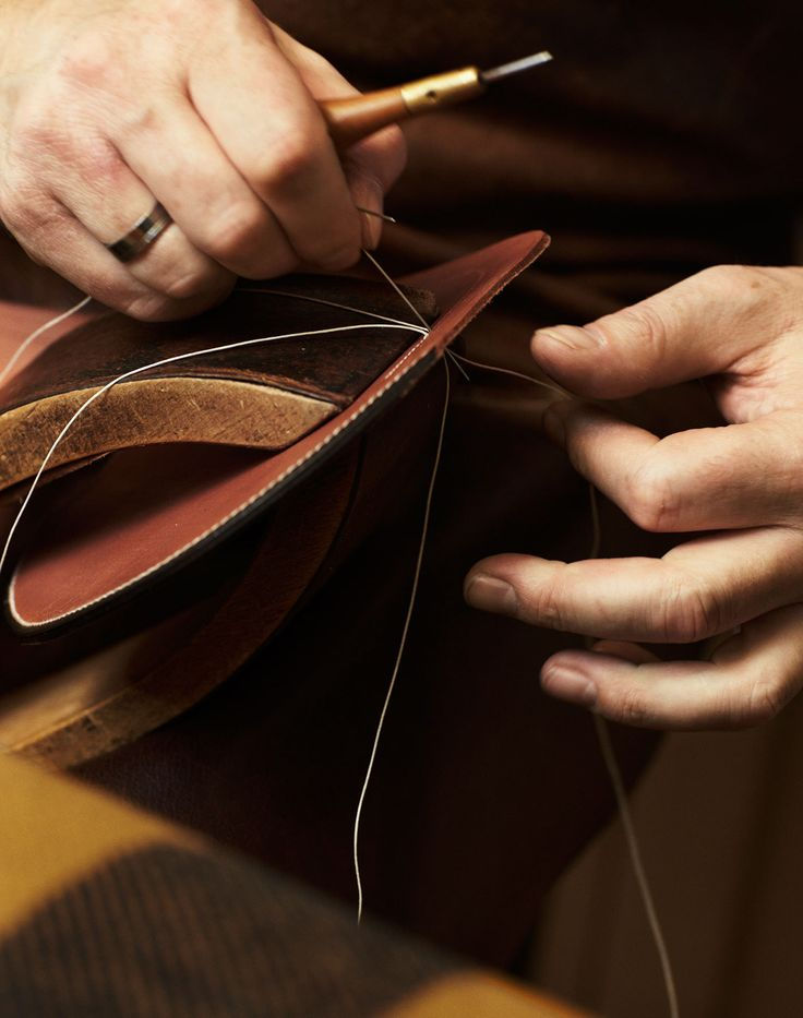  Hands stitching leather by hand at the Hermès atelier, photographed by Giampaolo Vimercati.