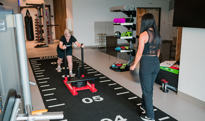 Personal trainer demonstrating expert training techniques with a client in downtown Greenville.